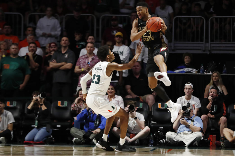 Florida State guard M.J. Walker (23) throws the ball into play against Miami guard Kameron McGusty (23) during overtime of an NCAA college basketball game on Saturday, Jan. 18, 2020, in Coral Gables, Fla. (AP Photo/Brynn Anderson)