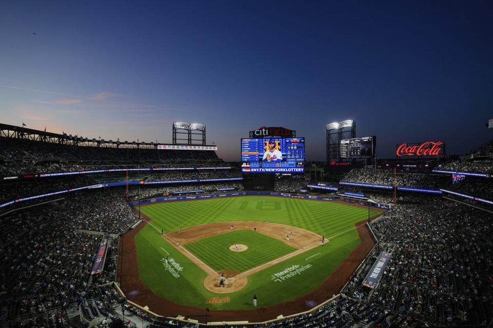 Fans watch the fourth inning of a baseball game between the New York Mets and the Arizona Diamondbacks, Friday, May 31, 2024, in New York. (AP Photo/Frank Franklin II)