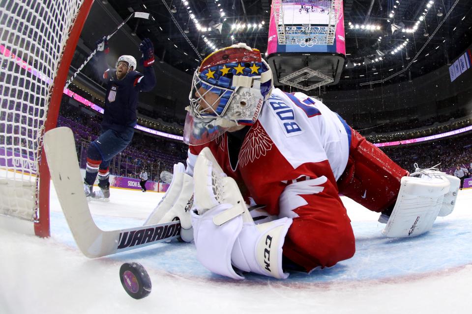 Phil Kessel #81 of the United States celebrates after teammate Cam Fowler #3 scored a goal on Sergei Bobrovski #72 of Russia in the second period during the Men's Ice Hockey Preliminary Round Group A game on day eight of the Sochi 2014 Winter Olympics at Bolshoy Ice Dome on February 15, 2014 in Sochi, Russia.