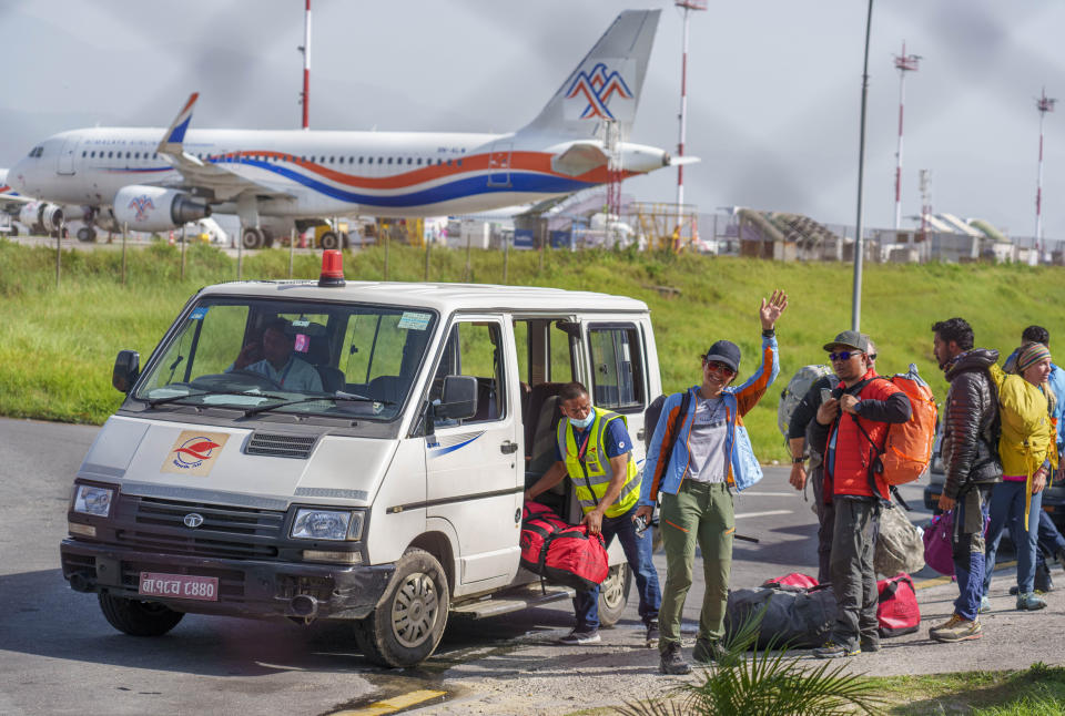 Ukrainian mountaineer Antonina Samoilova waves as she arrives at the airport after climbing Mount Everest, in Kathmandu, Nepal, Tuesday, May 17, 2022. Hundreds of climbers who scaled Mount Everest over the last few days taking advantage of favorable weather conditions have begun to return safely down the mountain. Samoilova said she hoped her achievement would call more attention to the war in her country. (AP Photo/Niranjan Shrestha)