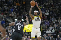 Utah Jazz guard Jordan Clarkson (00) shoots as Los Angeles Clippers forward Marcus Morris Sr. (8) defends during the first half of an NBA basketball game Wednesday, Nov. 30, 2022, in Salt Lake City. (AP Photo/Rick Bowmer)