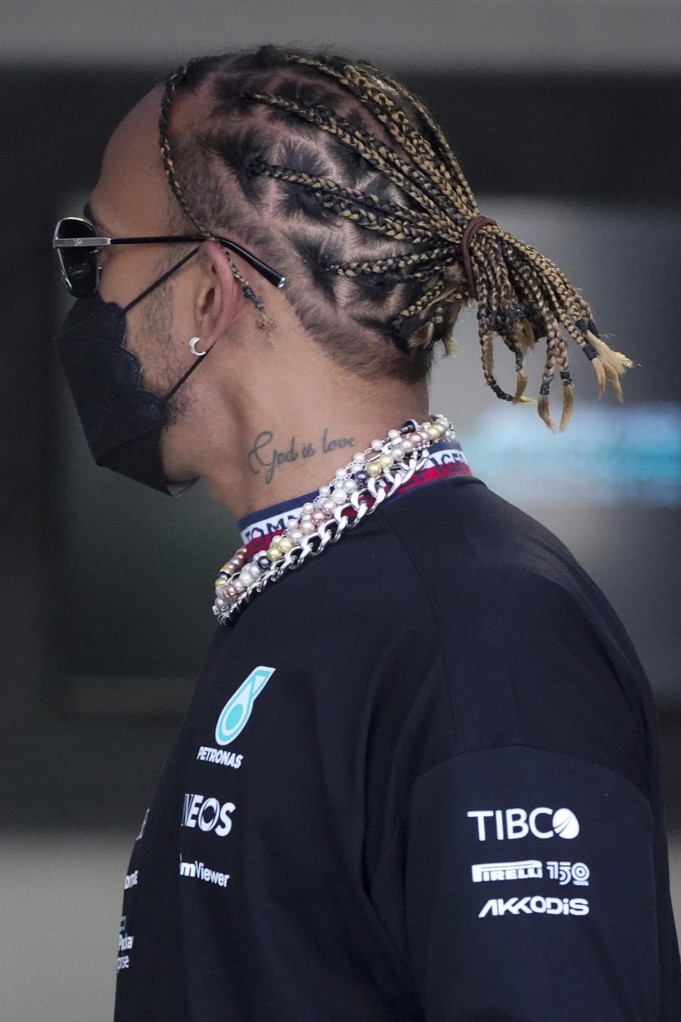 Mercedes driver Lewis Hamilton of Britain arrives for the first practice session for the Formula One Miami Grand Prix auto race wearing various items of jewelry at the Miami International Autodrome, Friday, May 6, 2022, in Miami Gardens, Fla. (AP Photo/Wilfredo Lee)