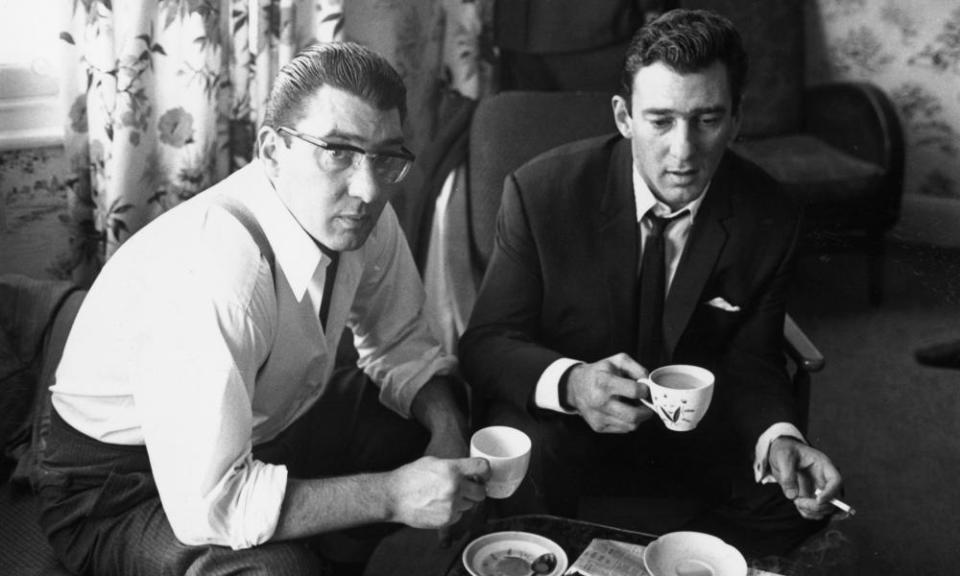 The gangsters Ronnie and Reggie Kray at home having a cup of tea.