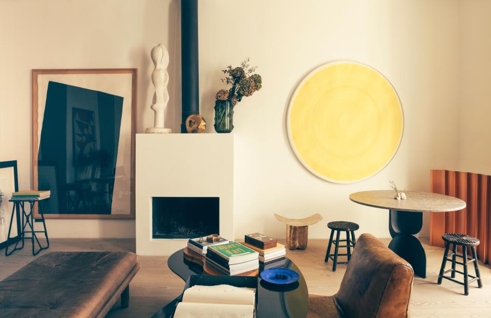 A wall displays part of Champsaur’s art collection, including a Richard Serra lithograph to the left, and a yellow painting by Swiss artist Carmen Perrin. On the mantel is an anonymous plaster sculpture and a vase by French designer Eric Schmitt. The leather chair is from the Paris flea market, and the coffee table and dining table are both Champsaur designs for Pouenat Ferronnier. The diminutive bronze in the background is also a Champsaur design, this for Maison Intègre.