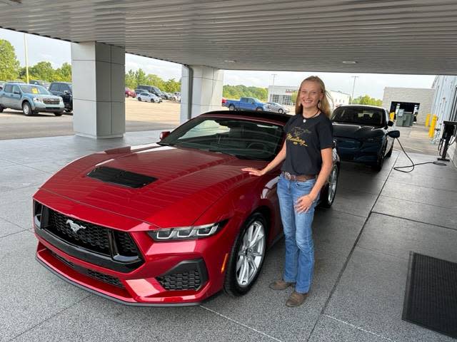 Kelly Ward, seen here in April 2023, when she purchased her Ford Mustang from Morrie's Grand Ledge Ford in Eaton County, Michigan. She saved up $40,000 to put down on the classic internal combustion engine pony car.