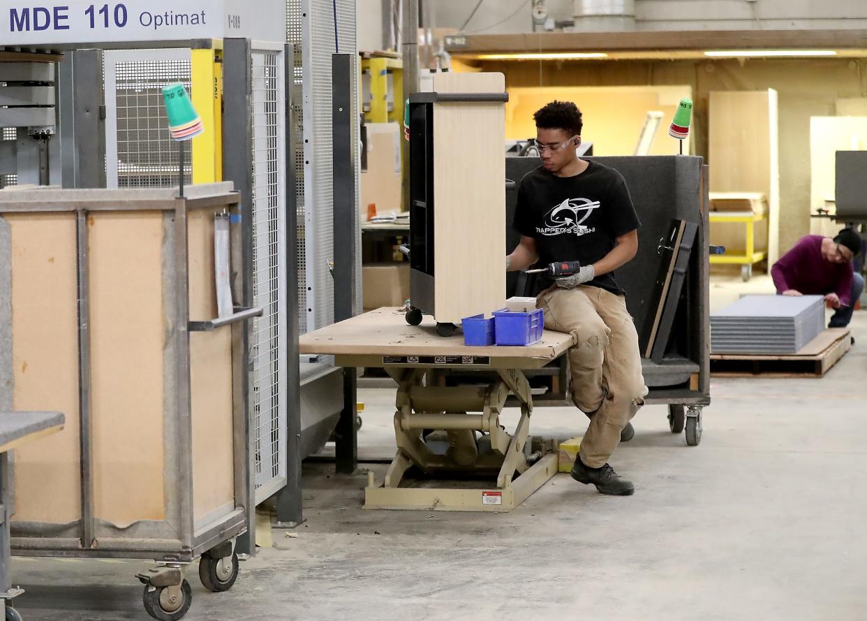 A Watson Furniture employee assembles a storage unit in this 2020 photo from Kitsap Sun archives. The Poulsbo manufacturer of office furniture was affected by the pandemic's effect on in-person work, but now is expanding warehouse capacity and investing in new technology at its North Kitsap plant.
