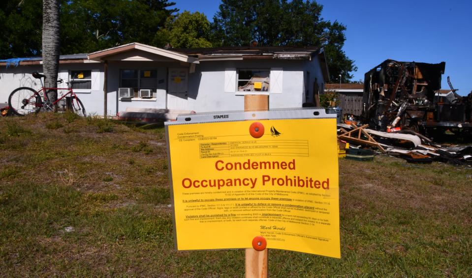 Melbourne code enforcement officials posted yellow "Condemned Occupancy Prohibited" signs at the derelict home on Tuesday.