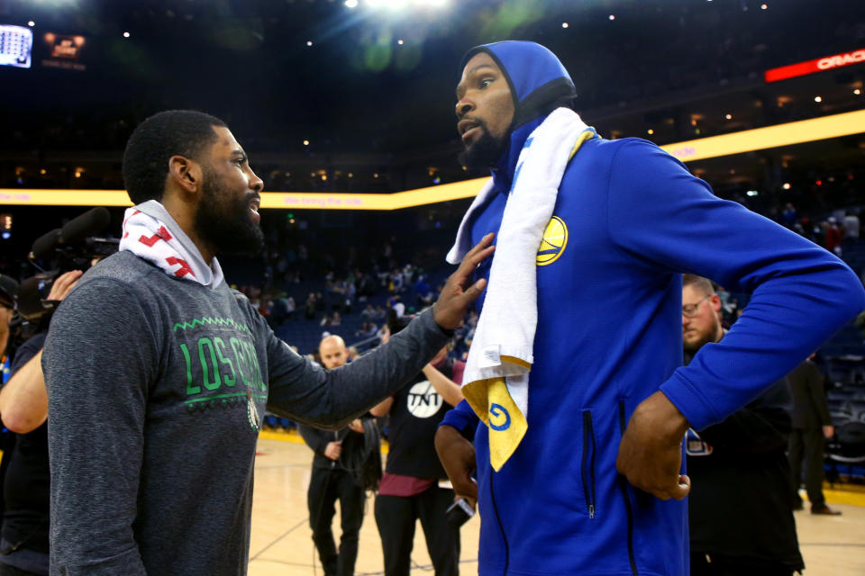 OAKLAND, CALIFORNIA - MARCH 5: Boston Celtics' Kyrie Irving (11) talks with Golden State Warriors' Kevin Durant (35) after the Warriors lost128-95 at Oracle Arena in Oakland, Calif., on Tuesday, March 5, 2019. (Photo by Ray Chavez/MediaNews Group/The Mercury News via Getty Images)