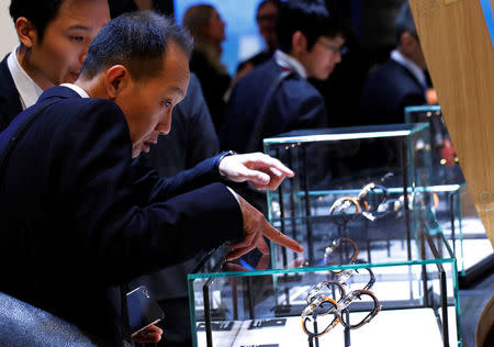Visitors look at watches at the Montblanc stand at the "Salon International de la Haute Horlogerie" (SIHH) watch fair, organised by the Richemont group, in Geneva, Switzerland, January 15, 2018. REUTERS/Denis Balibouse
