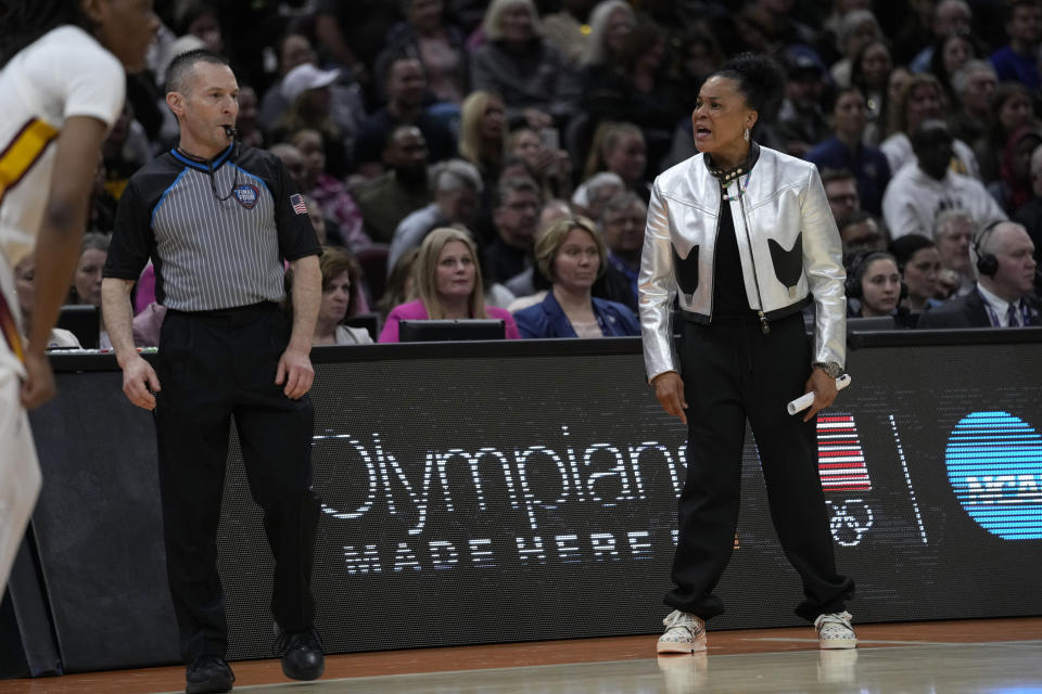 South Carolina head coach Dawn Staley, right, reacts to a call during the first half of the Final Four college basketball championship game against Iowa in the women's NCAA Tournament, Sunday, April 7, 2024, in Cleveland. (AP Photo/Carolyn Kaster)