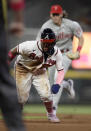 Atlanta Braves' Ronald Acuna Jr., left, is chased by Philadelphia Phillies' Alec Bohm during a rundown between first and second bases in the fifth inning of a baseball game Sunday, May 9, 2021, in Atlanta. Acuna was tagged out by Ranger Suarez. (AP Photo/Ben Margot)