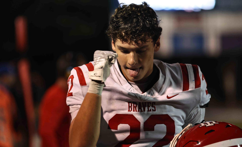 Indian Hill's Eli Riggs reacts after the Braves 21-3 win over Wyoming Friday, Oct. 13, 2023.