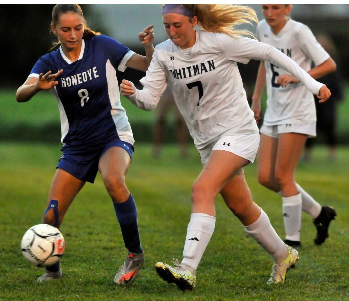 Honeoye's Leah Green, left, and Marcus Whitman's Katie Bootes battle for possession during Wednesday's game.