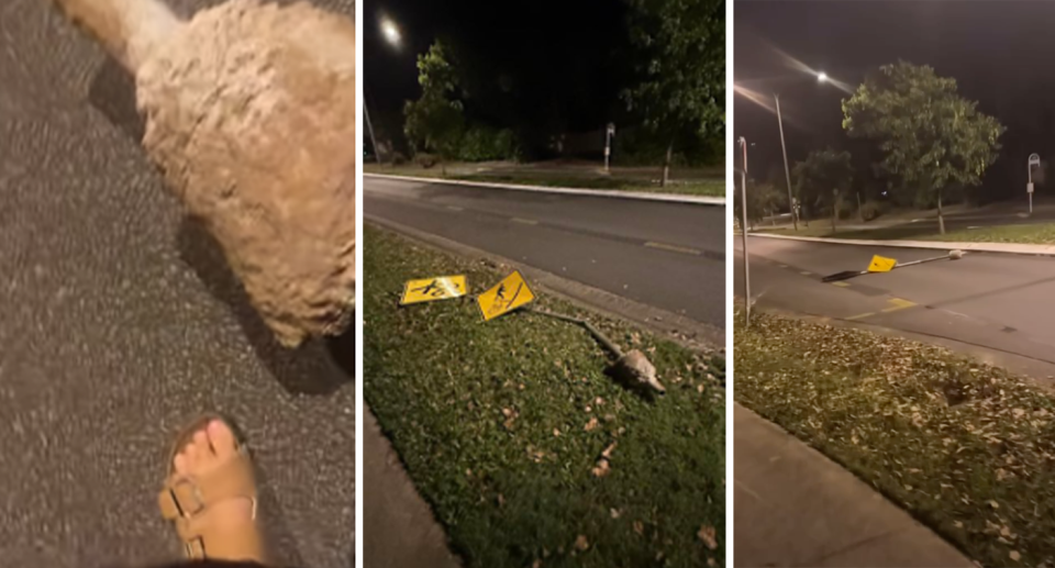 An uprooted road sign is seen in the middle of a street in Cairns. 