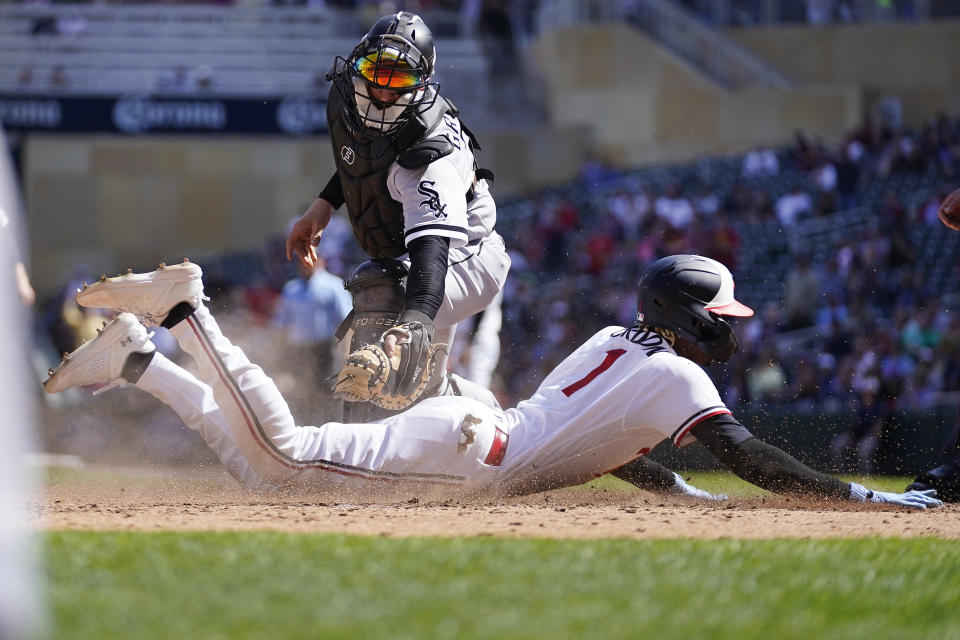Minnesota Twins' Nick Gordon beats the tag by Chicago White Sox catcher Yasmani Grandal to score during the fifth inning of a baseball game, Monday, April 10, 2023, in Minneapolis. (AP Photo/Abbie Parr)