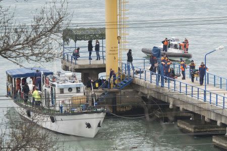 Russian Emergencies Ministry members work at a quay of the Black Sea near the crash site of Russian military Tu-154 plane, in the Sochi suburb of Khosta, Russia, Russia December 25, 2016. REUTERS/Yevgeny Reutov