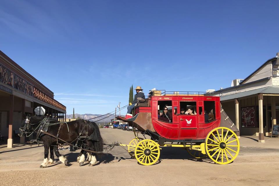 A horse-driven carriage is seen going through Tombstone, Ariz., on Saturday, Nov. 30, 2019. Tombstone is famous for a gun battle in 1881 that left three dead, a confrontation that has been the inspiration for numerous books and movies. While reenactments of the shootout are a popular tourist draw, the town has been working to offer a wide range of attractions that allow visitors to see what life was like in the Old West. (AP Photo/Peter Prengaman)