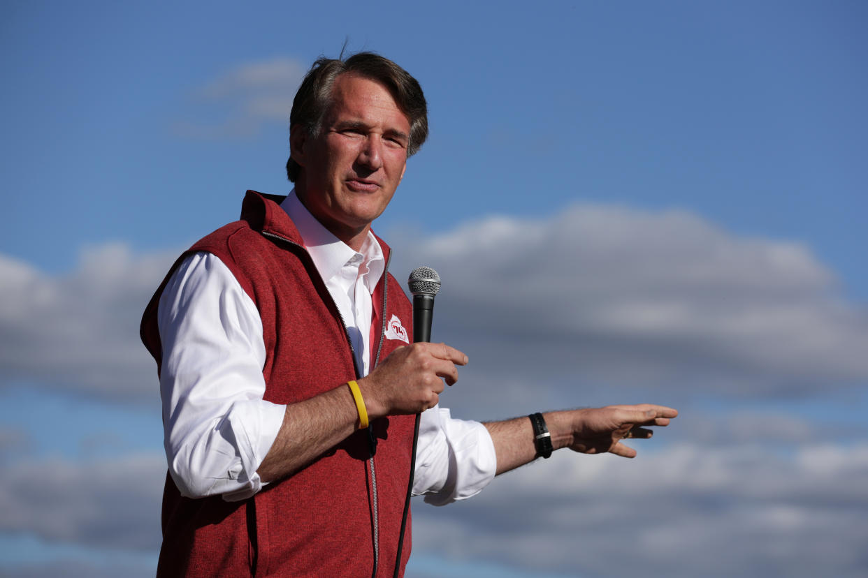 Gov. Glenn Youngkin against a big blue sky with a few gray clouds.