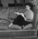 <p>Elizabeth dresses comfortably as she curls up on her sofa for a quiet moment of reading. </p>