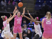 Iowa's Kate Martin (20) passes between Penn State's Makenna Marisa (20) and Chanaya Pinto (10) during the first half of an NCAA college basketball game, Sunday, Feb. 5, 2023, in State College, Pa. (AP Photo/Gary M. Baranec)