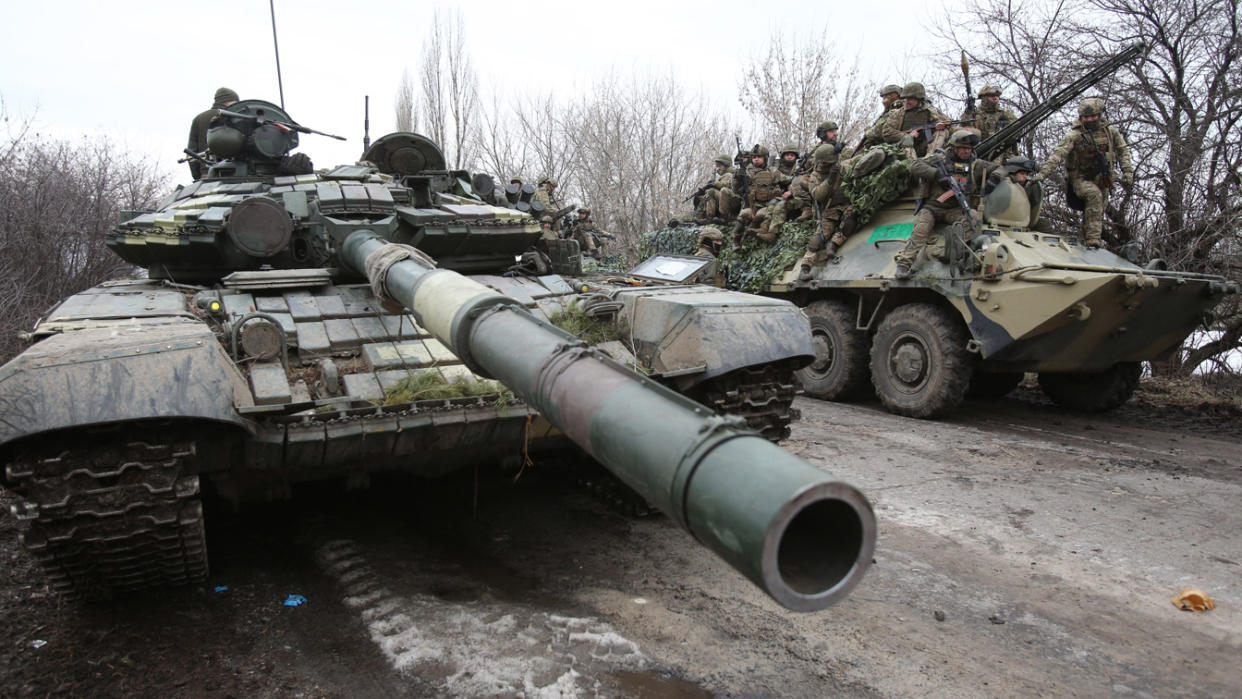 Ukrainian servicemen, in tanks, get ready to repel an attack.