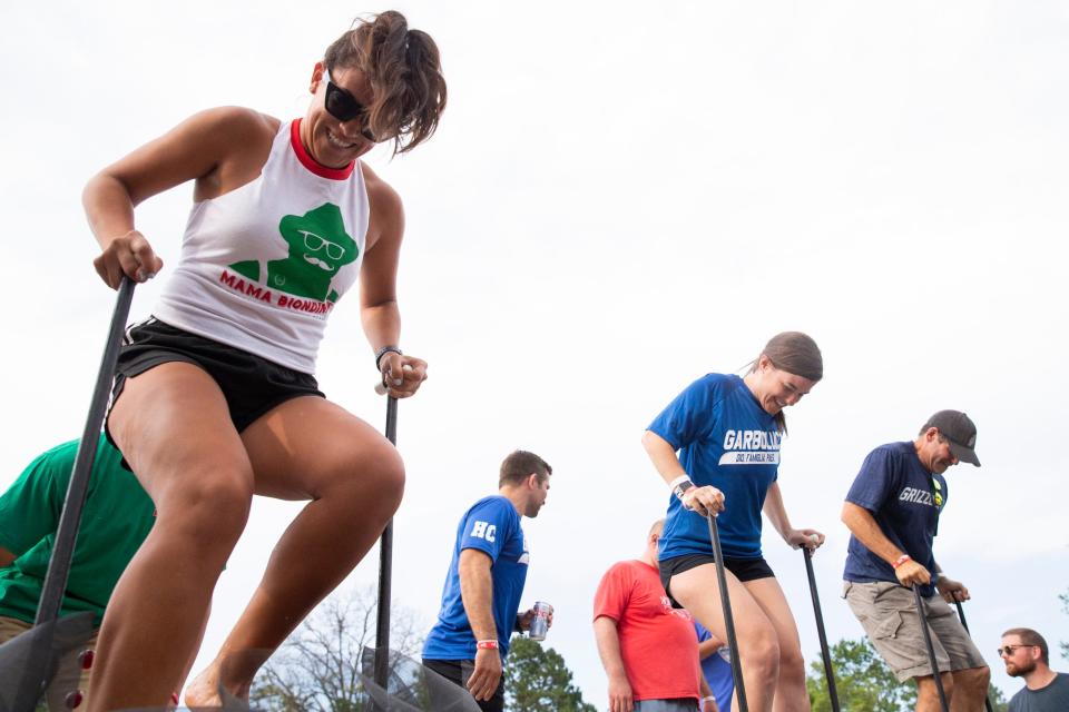 Carmen Manes, Lauren Wilson and Jeff Seidman compete in the grape stomping competition during the Memphis Italian Festival at Marquette Park in Memphis, Tenn., on Friday, June 2, 2023. 