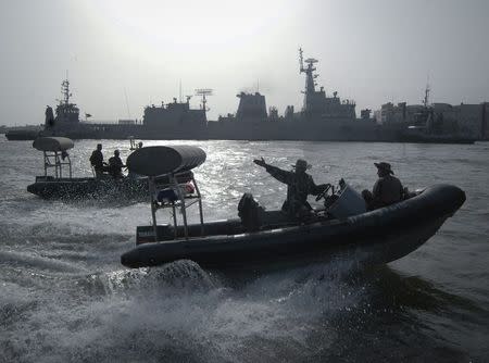 Pakistan Navy personnel keep guard near the Navy ship PNS Zulfiqar after it returned to Karachi in this June 23, 2011 file photo. REUTERS/Stringer/Files