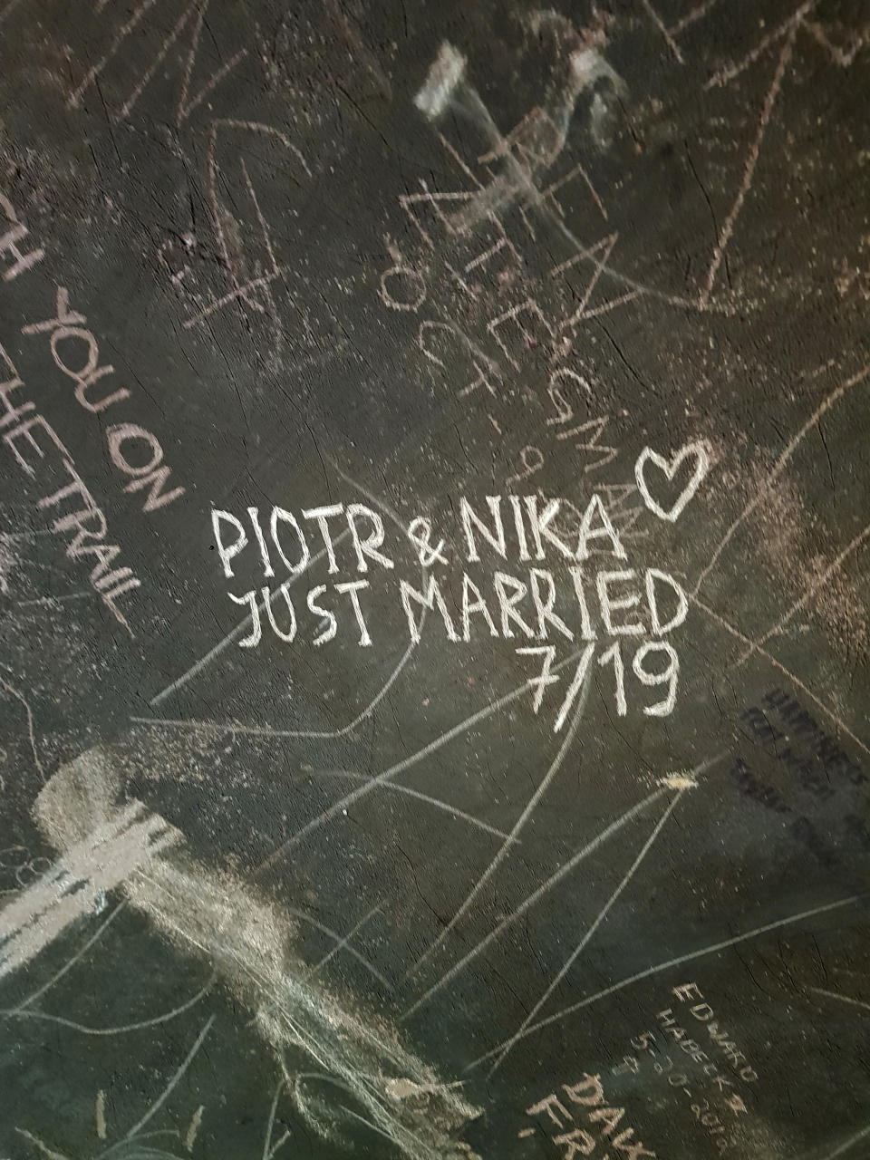 This undated photo provided by Piotr Markielau shows what he and his wife, Veranika Nikonova, scratched on an abandoned bus in the Alaska wilderness shortly before she died on July 25, 2019, following her struggle to cross the Teklanika River. Markielau said he frantically tried but failed to save his wife as she struggled to cross the river near a bus in the Alaska wilderness made famous by the movie "Into the Wild." (Piotr Markielau via AP)