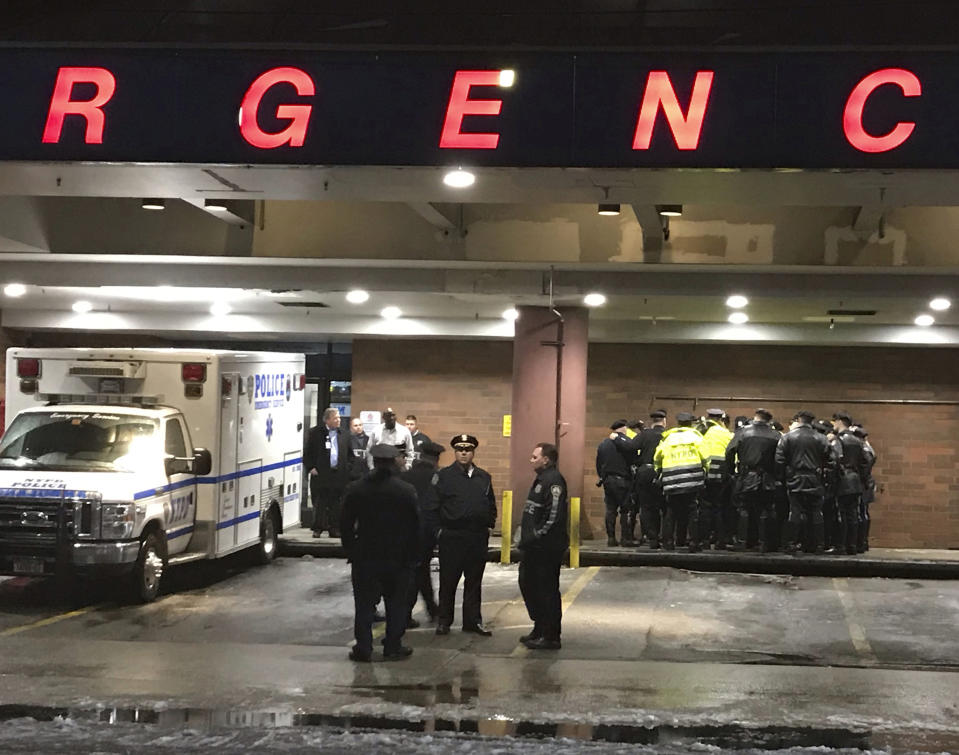 New York City police officers gather at Jamaica Hospital in the Queens borough of New York after a few NYPD officers while responding to a robbery in a mobile phone store on Tuesday, Feb. 12, 2019. One of them was killed Tuesday night while responding to a report of a gunpoint robbery at a cellphone store, an official briefed on the matter told The Associated Press. The official was not authorized to speak publicly and spoke on condition of anonymity. (AP Photo/Stephen Groves)