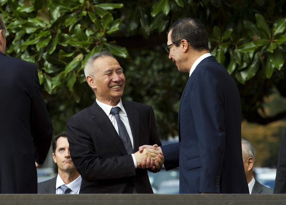 Chinese Vice Premier Liu He shake hands with Treasury Secretary Steven Mnuchin, as he arrives for a minister-level trade meeting in Washington, Thursday, Oct. 10, 2019. (AP Photo/Jose Luis Magana)