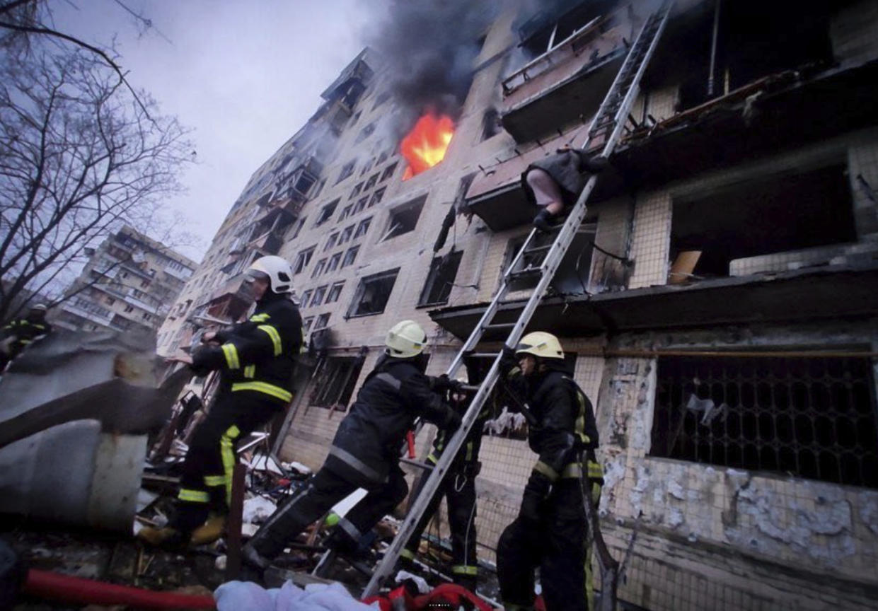 In this photo released by Ukrainian State Emergency Service press service, firefighters work at an apartment building hit by shelling in Kyiv, Ukraine, Monday, March 14, 2022. (Ukrainian State Emergency Service via AP)