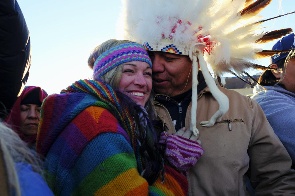 Lance King, 33, an Oglala Lakota from Lyle, South Dakota, celebrates with Kayti Bunny after the announcement that the Army Corps of Engineers denied the easement to drill under Lake Oahe for the Dakota Access Pipeline.