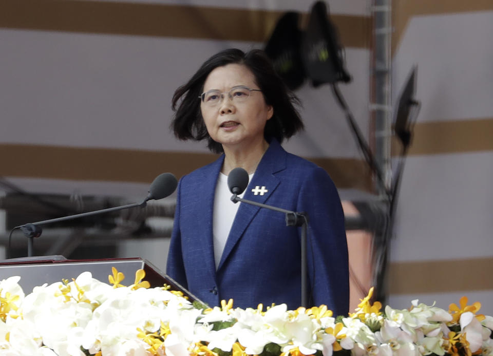 FILE - In this Oct. 10, 2021, file photo, Taiwanese President Tsai Ing-wen delivers a speech during National Day celebrations in front of the Presidential Building in Taipei, Taiwan. After sending a record number of military aircraft to harass Taiwan over China’s National Day holiday weekend, Beijing has toned down the sabre rattling but tensions remain high, with the rhetoric and reasoning behind the exercises unchanged. (AP Photo/Chiang Ying-ying, File)