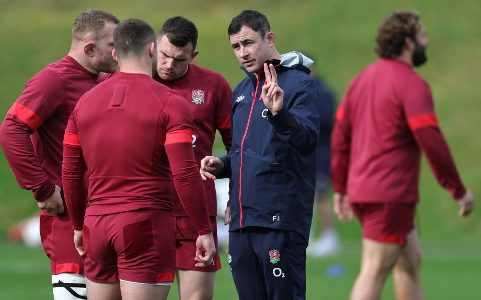 Felix Jones chats to England's forwards during training