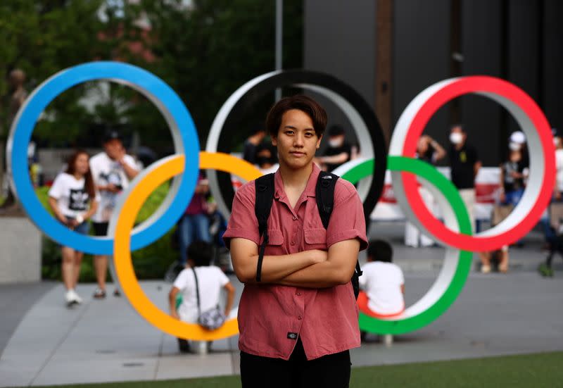 Tsubata, nurse and boxer, poses in front of the Olympic Rings in Tokyo