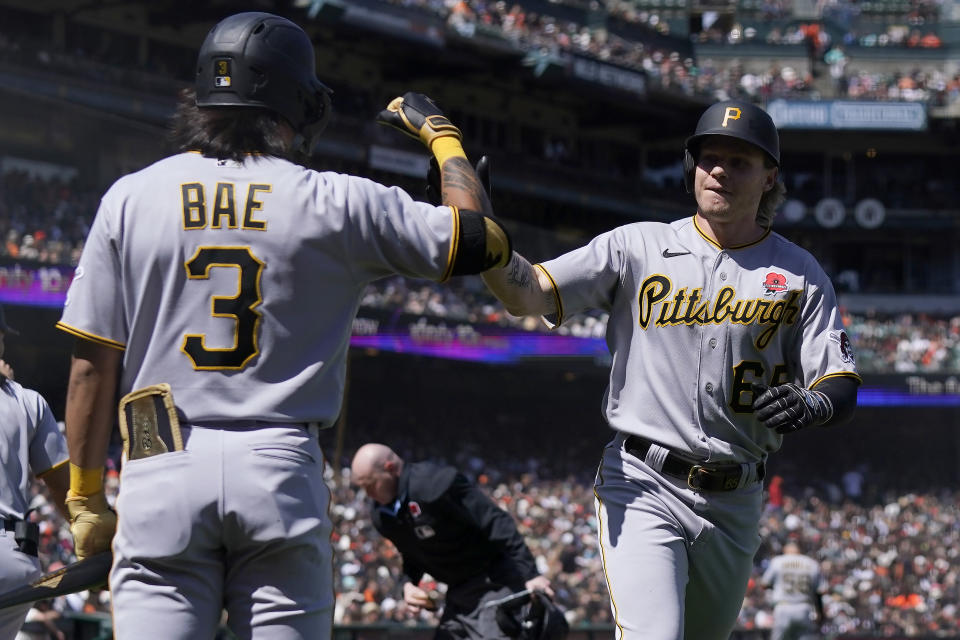 Pittsburgh Pirates' Jack Suwinski, right, is congratulated by Ji Hwan Bae (3) after hitting a home run against the San Francisco Giants during the seventh inning of a baseball game in San Francisco, Monday, May 29, 2023. (AP Photo/Jeff Chiu)
