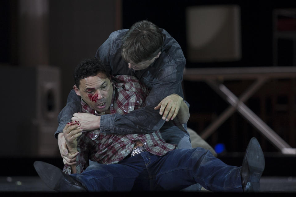 In this photo taken on Friday, Jan. 24, 2014, American tenor Tom Randle (Jack Twist), left, and Canadian bass-baritone Daniel Okulitch (Ennis del Mar), right, perform during the press rehearsal of the production "Brokeback Mountain" at the Teatro Real, in Madrid, Spain. It was a short story, then a Hollywood movie. Now the tragic tale of cowboys in love is being reinvented again: Brokeback Mountain _ the opera. Ahead of its world premiere in Madrid, author Annie Proulx told The Associated Press that the form of opera presented an opportunity to explore the complexities of the tale in a way neither her own short story nor the movie by director Ang Lee were able to do. (AP Photo/Gabriel Pecot)