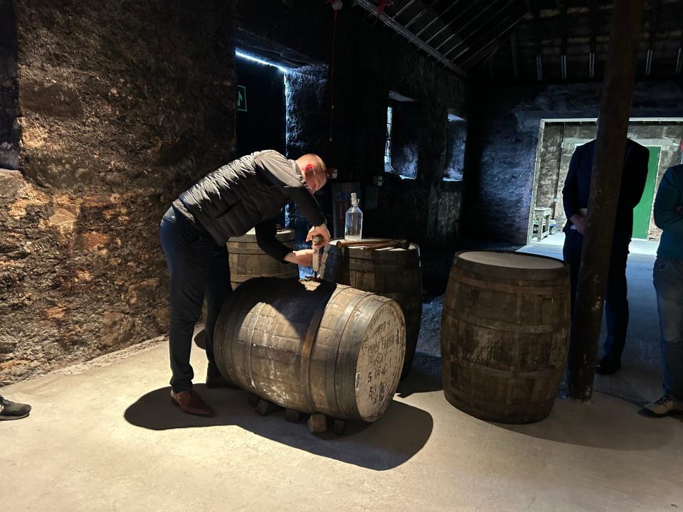 Man opening a vintage whisky cask