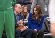 <p>The royals laugh together while sitting courtside.</p>