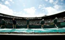 Britain Tennis - Wimbledon - All England Lawn Tennis & Croquet Club, Wimbledon, England - 1/7/16 Groundstaff pull the cover off court 1 after a rain delay REUTERS/Andrew Couldridge