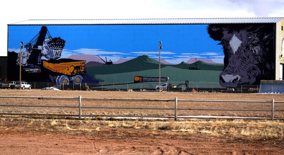 A giant mural on the side of a building in Gillette, Wyoming highlights the state's two sources of income: Coal mining and cattle ranching.