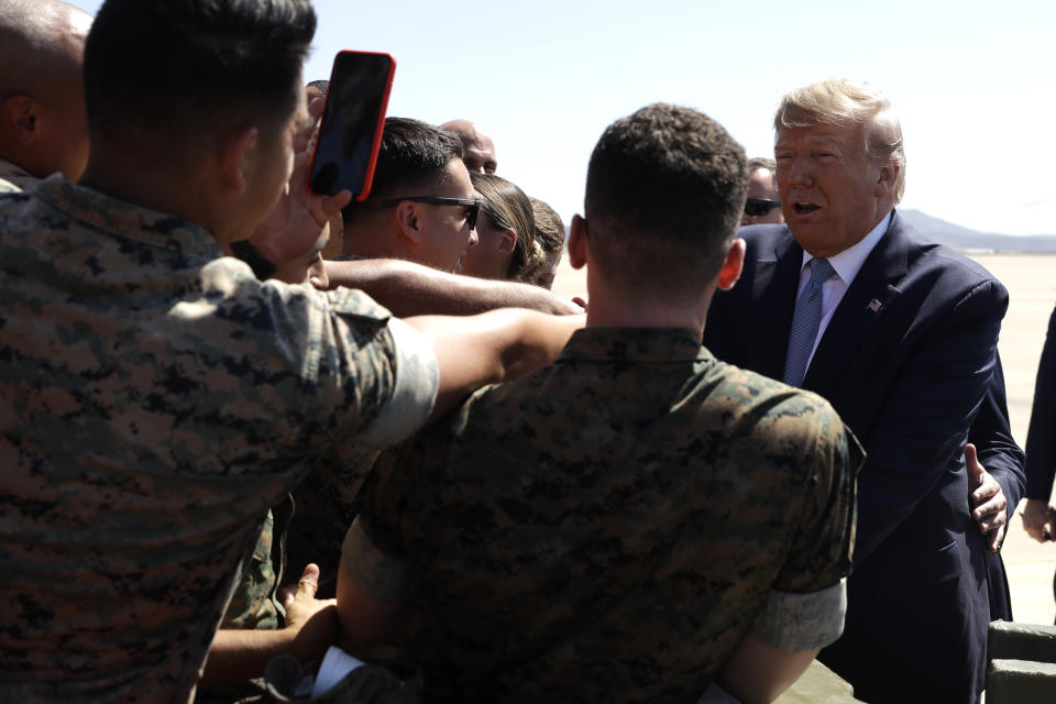 President Donald Trump greets people as he arrives at Marine Corps Air Station Miramar to attend a fundraiser and visit a section of the border wall, Wednesday, Sept. 18, 2019, in San Diego. (AP Photo/Evan Vucci)
