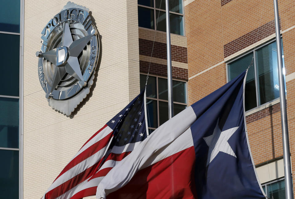 The American and Texas flag sit at half-staff outside of the Dallas police department headquarters