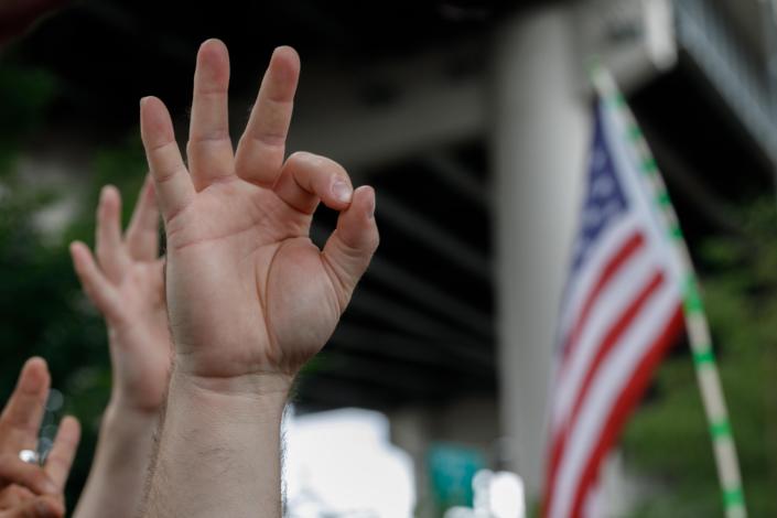 A far-right demonstrator makes the OK hand gesture believed to have white supremacist connotations during &quot;The End Domestic Terrorism&quot; rally at Tom McCall Waterfront Park on August 17, 2019 in Portland, Oregon. - No major incidents were reported on Saturday afternoon in Portland (western USA) during a far-right rally and far-left counter-demonstration, raising fears of violent clashes between local authorities and US President Donald Trump, who was monitoring the event &quot;very closely&quot;. (Photo by John Rudoff / AFP)        (Photo credit should read JOHN RUDOFF/AFP/Getty Images)