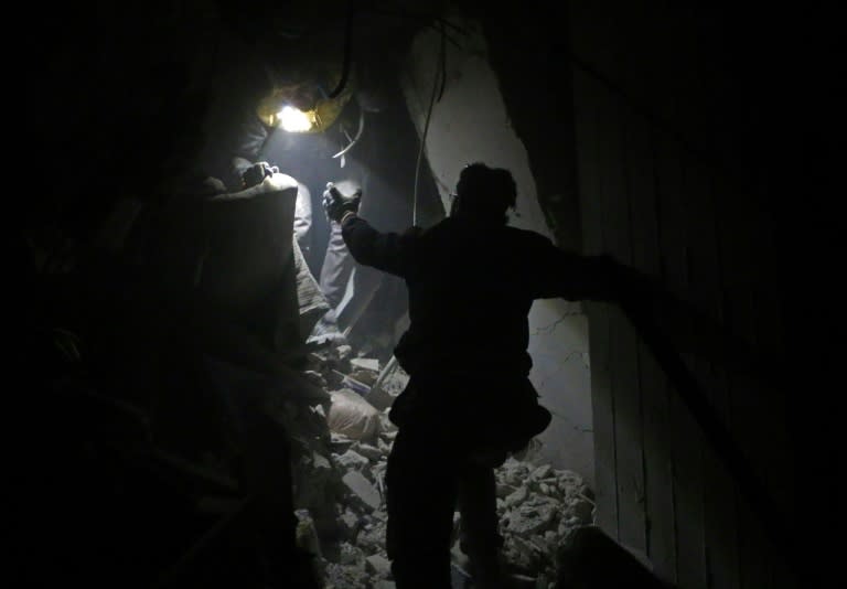 Syrian rescuers work in the battered rebel enclave Eastern Ghouta on February 22, 2018