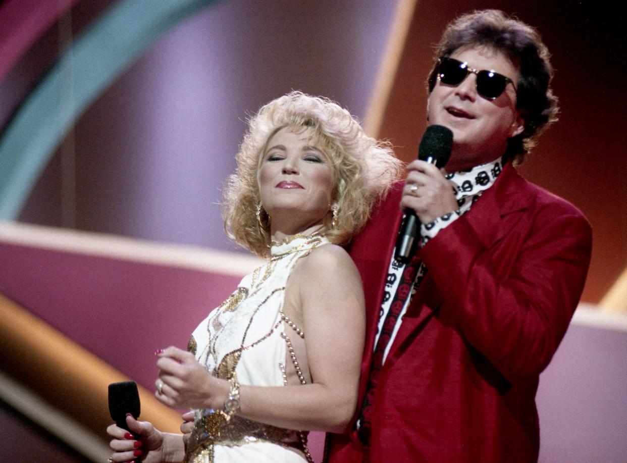 Tanya Tucker, left, and T. Graham Brown strut their stuff on their steamily Vocal Event of the Year nominated duet "Don't Go Out" during the 24th annual CMA Awards show at the Grand Ole Opry House Oct. 8, 1990.