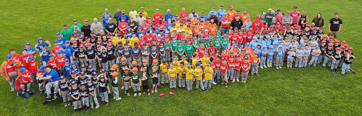 All of the players and coaches gather for a group picture during Saturday's opening day at the Cambridge City Park for Cambridge Little League. There are 330 participants this year that are ready to play. Ages range from three to thirteen. Cambridge League was chartered in 1952 and still going strong.