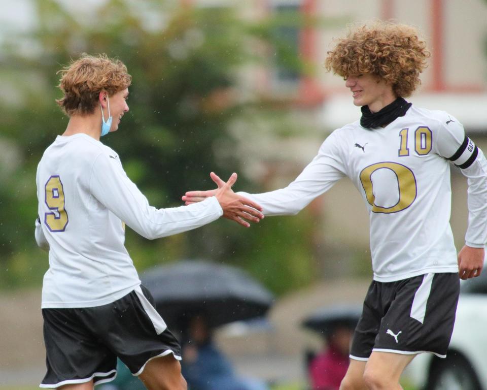 Onsted's Brennan Goodrow (10) and Alexander Slaviero (9) celebrate a goal during Monday's game at Clinton.