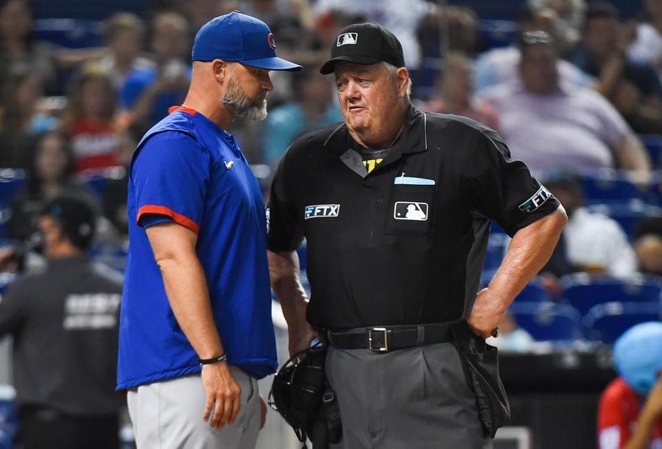 Manager David Ross of the Chicago Cubs talks with umpire Joe West. (Photo by Eric Espada/Getty Images)