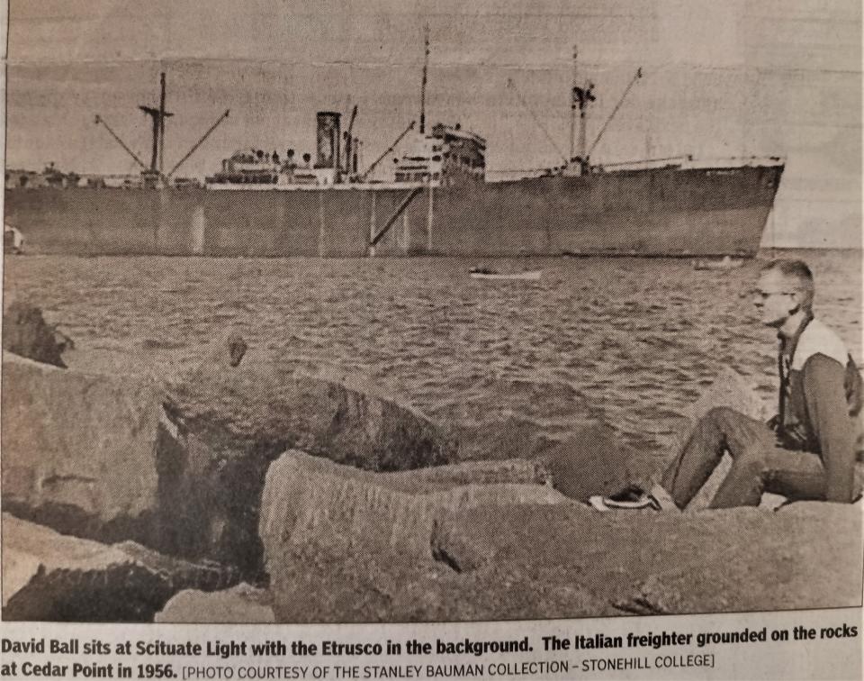 In this 1956 photo, David Ball is sitting on the Scituate shoreline with the grounded freighter SS Etrusco in the background. On a cold night in March 1956, a nor’easter raced up the Eastern seaboard as the Italian freighter ran aground along the rocky shore next to Scituate Light. The crew of the Etrusco was rescued by the Coast Guard the next day.